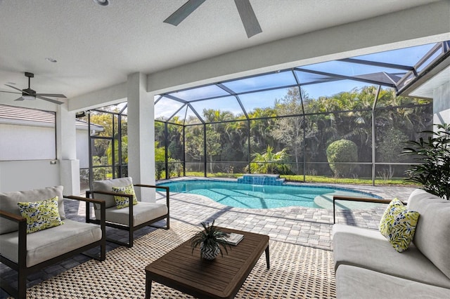 view of pool featuring outdoor lounge area, ceiling fan, a lanai, and a patio