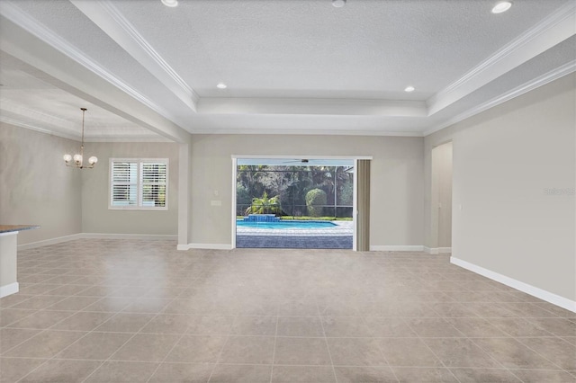 unfurnished living room with a raised ceiling, crown molding, and a notable chandelier