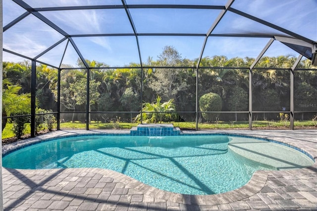 view of pool with a lanai, a patio area, pool water feature, and a hot tub