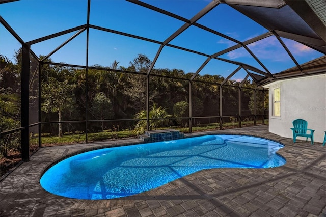 view of pool featuring a jacuzzi, a patio, and glass enclosure