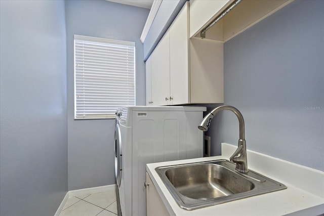 washroom with washer / clothes dryer, light tile patterned floors, cabinets, and sink