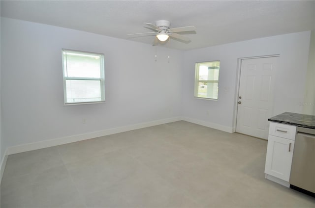 unfurnished room with ceiling fan and a healthy amount of sunlight