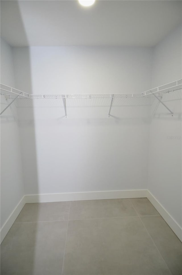 walk in closet with tile patterned floors