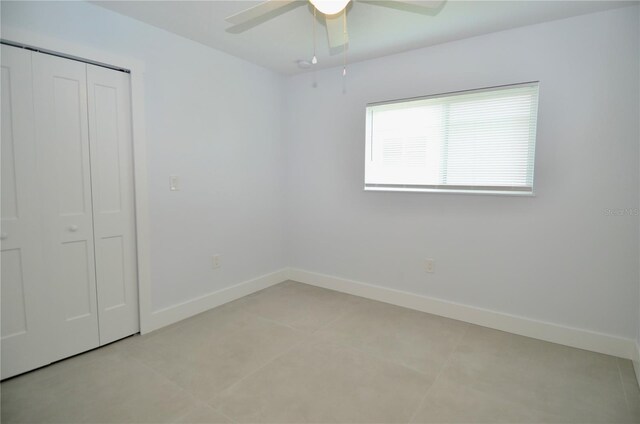 unfurnished bedroom featuring a closet and ceiling fan