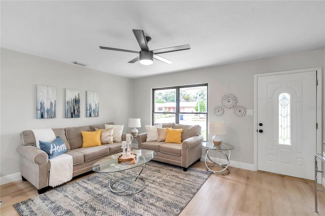 living room with ceiling fan and light hardwood / wood-style floors