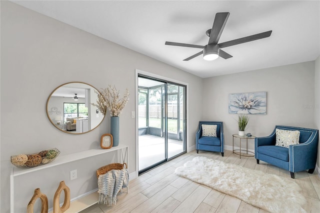 living area with plenty of natural light, ceiling fan, and light wood-type flooring