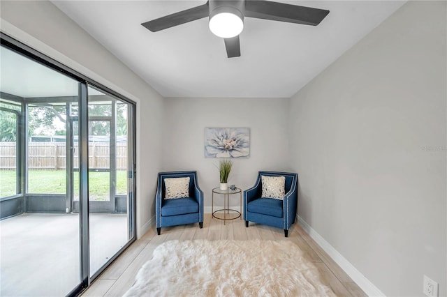 living area featuring light wood-type flooring and ceiling fan