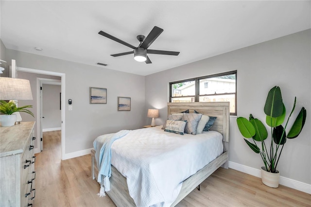 bedroom with light wood-type flooring and ceiling fan