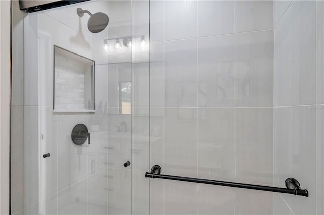 bathroom featuring a shower with door