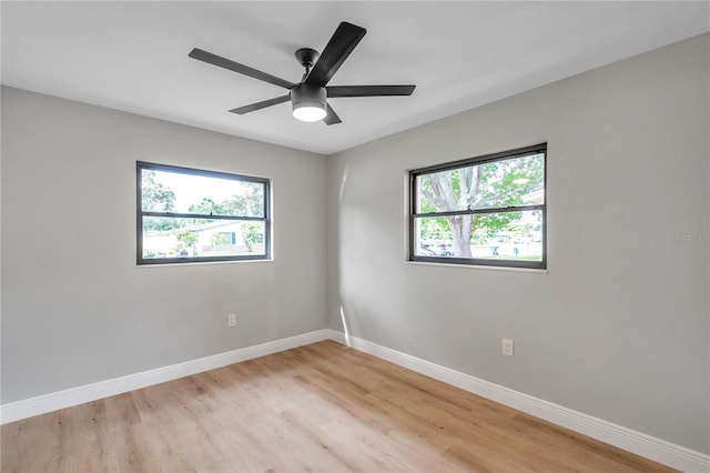 empty room featuring light wood-type flooring and ceiling fan