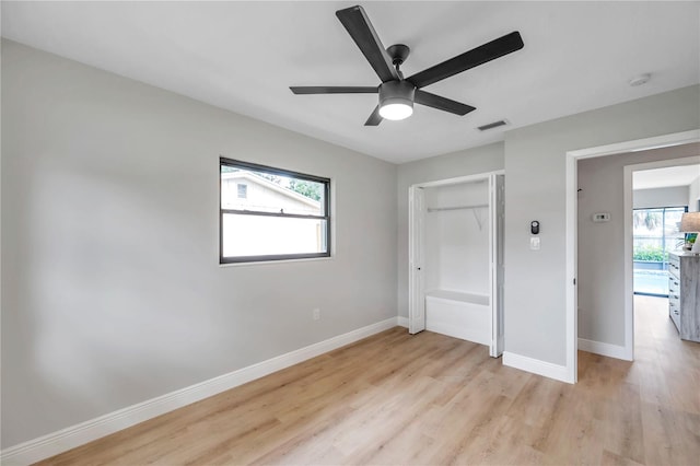 interior space with ceiling fan, a wealth of natural light, and light hardwood / wood-style floors