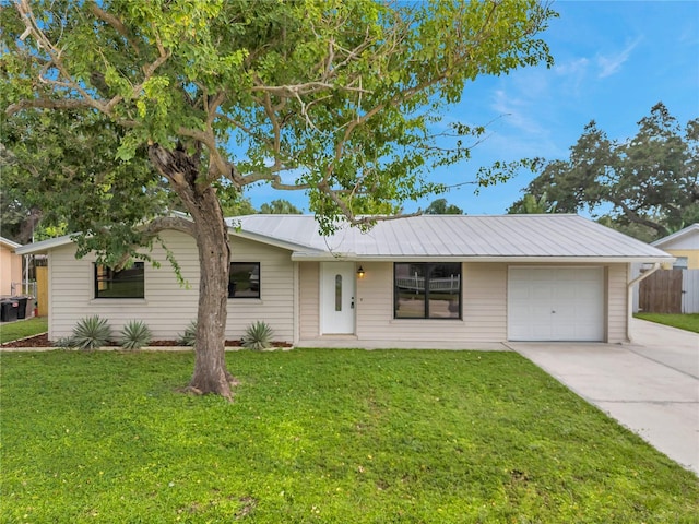 single story home with a front yard and a garage