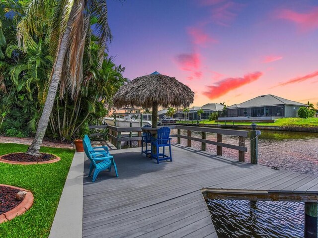 dock area with a water view and a residential view