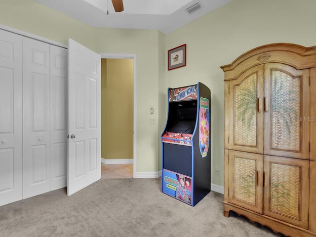 rec room with visible vents, baseboards, light colored carpet, and a ceiling fan