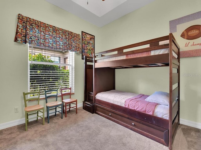 carpeted bedroom featuring baseboards