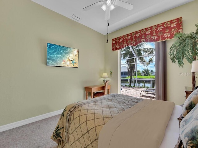 bedroom featuring access to exterior, visible vents, baseboards, carpet flooring, and a ceiling fan