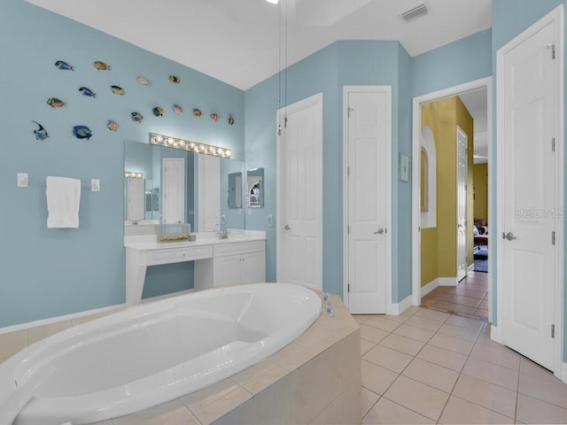 full bath featuring visible vents, baseboards, a garden tub, tile patterned floors, and vanity