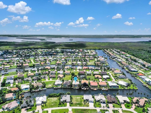 drone / aerial view with a residential view and a water view