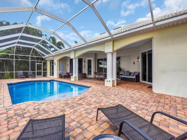 pool with a lanai, a patio area, and an outdoor hangout area