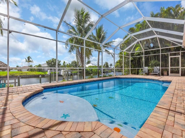 pool featuring a water view, a lanai, and a patio area