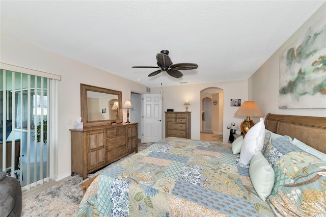 bedroom featuring light hardwood / wood-style flooring, ceiling fan, and access to outside