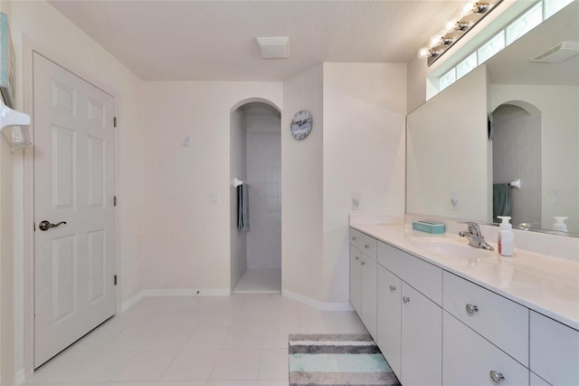 bathroom featuring a textured ceiling, vanity, and tile patterned floors