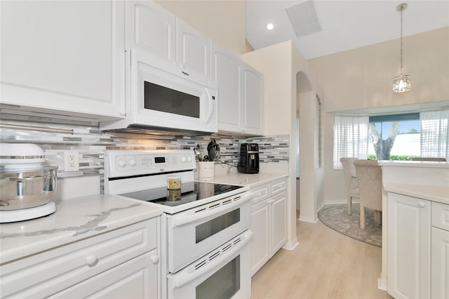 kitchen featuring pendant lighting, light wood-type flooring, white cabinets, white appliances, and backsplash