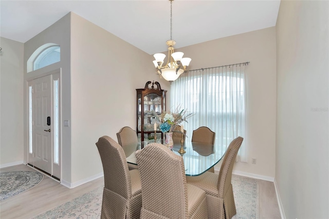 dining area featuring an inviting chandelier and light hardwood / wood-style floors