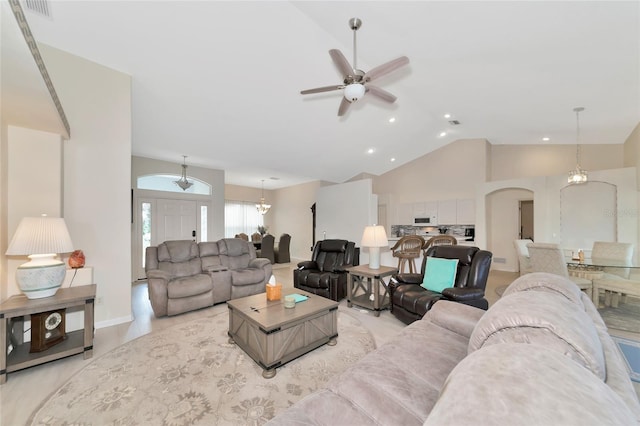 living room with ceiling fan and high vaulted ceiling