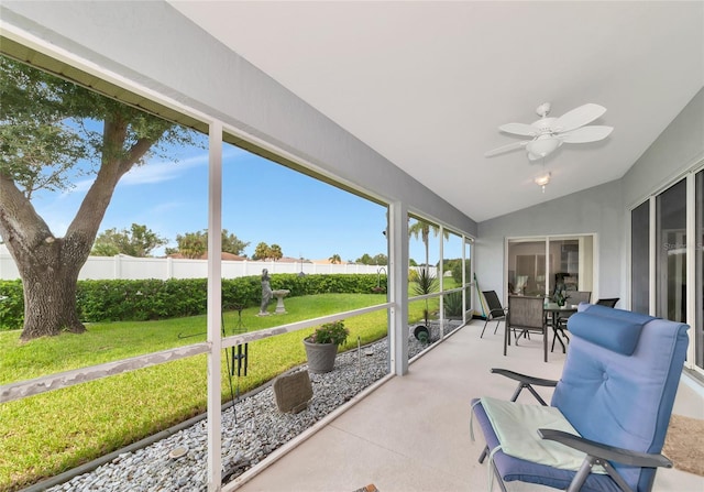 sunroom featuring lofted ceiling and ceiling fan