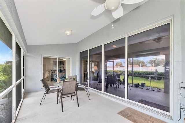 sunroom featuring vaulted ceiling, ceiling fan, and a wealth of natural light