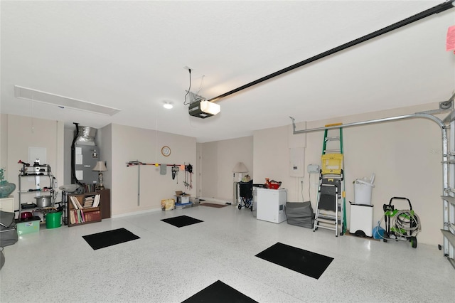 garage featuring a garage door opener and heating unit