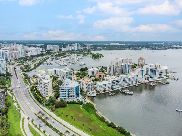 drone / aerial view featuring a water view and a view of city