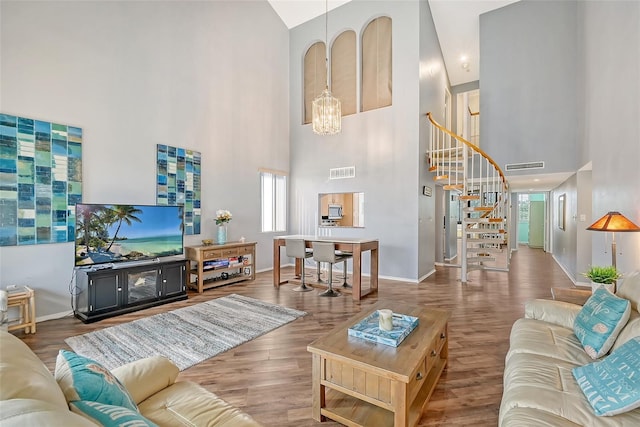 living room with a healthy amount of sunlight, dark hardwood / wood-style floors, and high vaulted ceiling