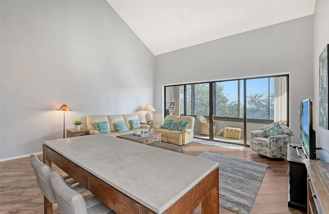 interior space with high vaulted ceiling and hardwood / wood-style flooring