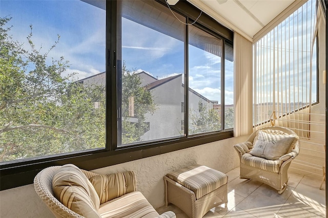 sunroom / solarium featuring vaulted ceiling and plenty of natural light