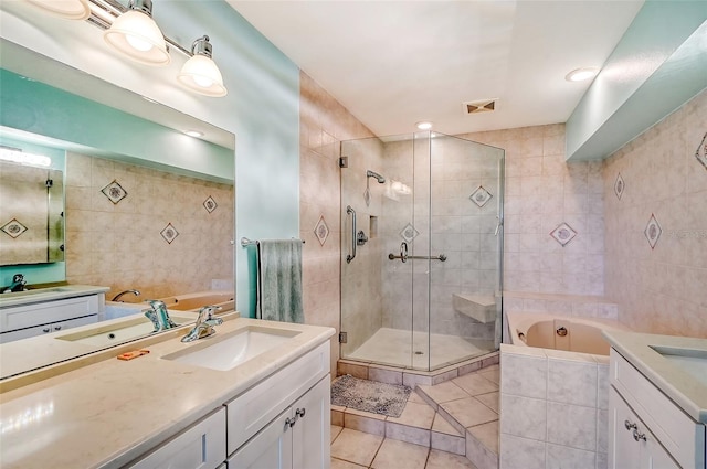 bathroom featuring vanity, tile walls, separate shower and tub, and tile patterned floors