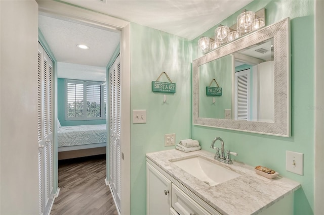 bathroom with vanity and hardwood / wood-style floors