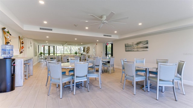 dining area with ceiling fan and light hardwood / wood-style floors