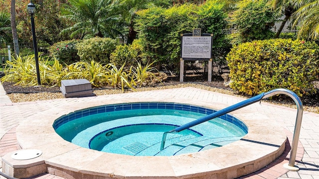 view of pool with a hot tub