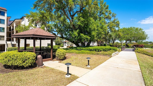 view of property's community featuring a lawn and a gazebo