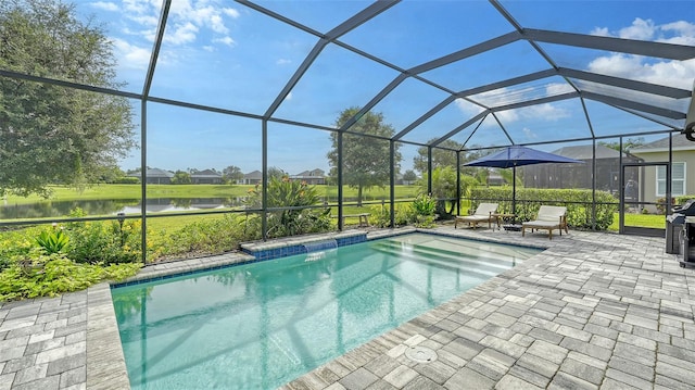 view of swimming pool featuring a lanai, a patio, and a water view