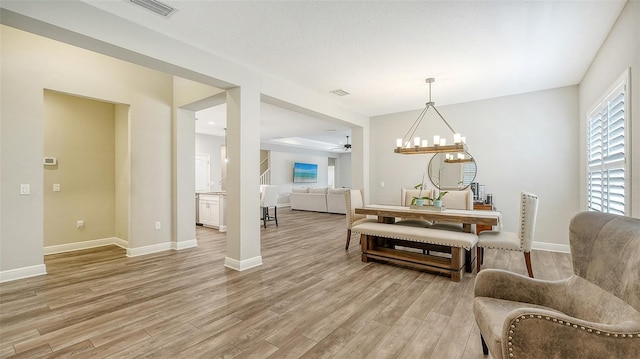 living area with wood-type flooring and ceiling fan