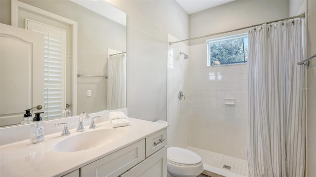 bathroom featuring toilet, vanity, and a shower with shower curtain