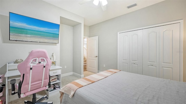 carpeted bedroom with a closet and ceiling fan