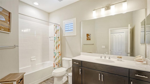 full bathroom featuring shower / tub combo with curtain, hardwood / wood-style floors, vanity, and toilet