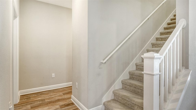 stairs featuring hardwood / wood-style floors