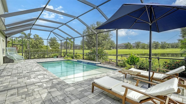 view of swimming pool with a patio, a water view, and a lanai