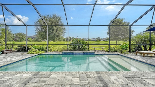 view of pool with glass enclosure and a patio