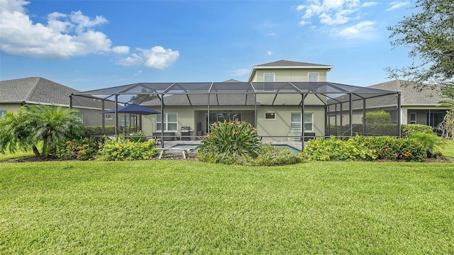 back of house featuring a patio, glass enclosure, and a yard